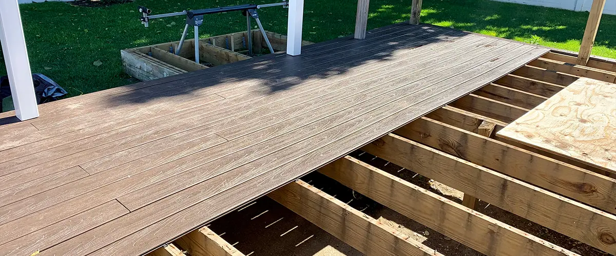 A deck building with composite decking and a pressure treated wood frame