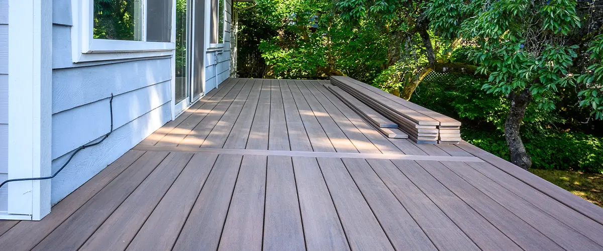 PVC decking with stacked boards on the side of the home